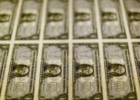 FILE PHOTO: United States one dollar bills on a light table at the Bureau of Engraving and Printing in Washington Nov. 14, 2014. REUTERS Gary Cameron/File Photo/File Photo