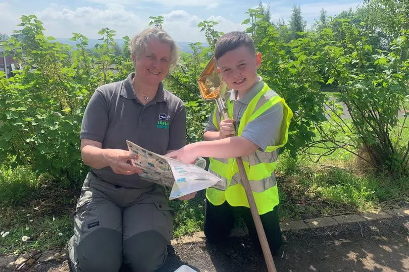 Kohen Fitzsimmons with Dawn Patterson at Bog Meadows on a bright day with greenery behind them