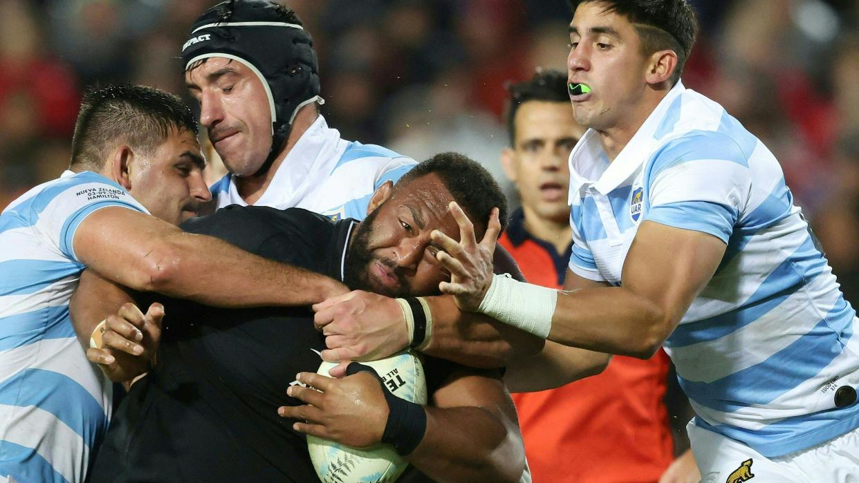  New Zealand's George Bower (C) is tackled during the rugby union Test match between New Zealand and Argentina 