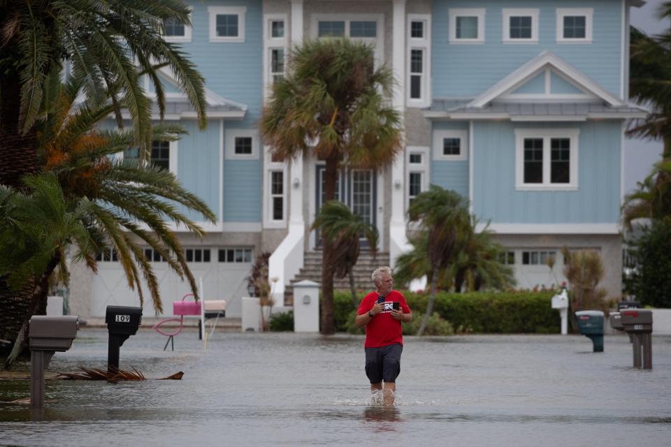 Mike Sellers surveys flood waters after wading in to check on his mother in the aftermath of Hurricane Idalia in Clearwater Beach, Florida (REUTERS)