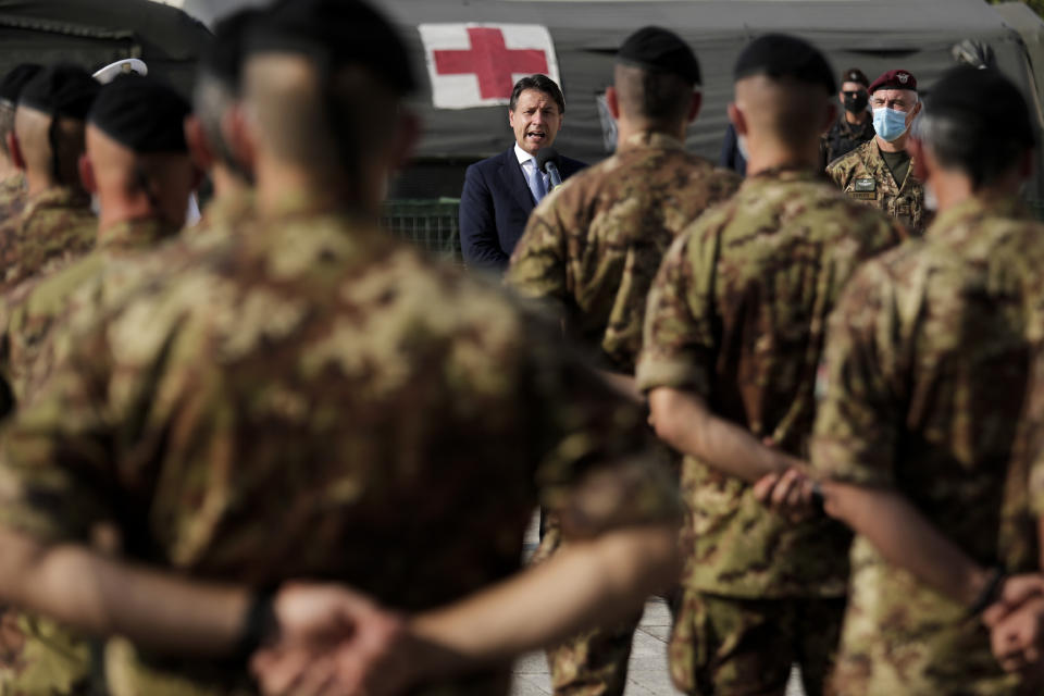 Italian Prime Minister Giuseppe Conte, center, addresses Italian soldiers as he visits an Italian field hospital set up at the Lebanese University in the Hadath district of Beirut, Lebanon, Tuesday, Sept. 8, 2020. Conte said Tuesday his country will support Lebanon's economic and social growth, expressing hopes that a new government is formed quickly — one that would start the reconstruction process in the wake of last month's Beirut explosion and implement badly needed reforms. (AP Photo/Hassan Ammar)