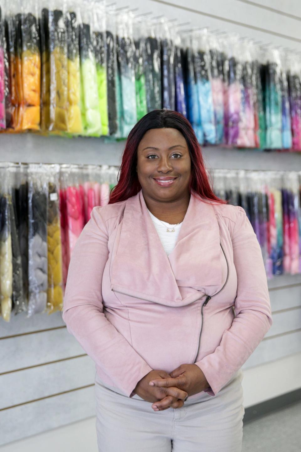 LaShai Perry, owner of Holley's Beauty Supplies, stands for a photo inside her Lafayette business, Thursday, Jan. 27, 2022.
