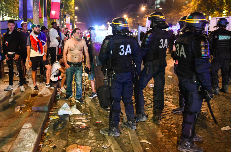 <em>Riot police were forced to deal with violent fans after France won the World Cup (Getty)</em>