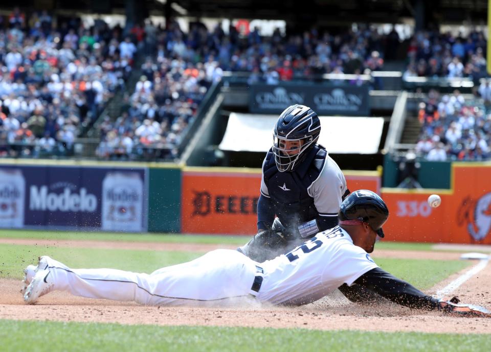 Detroit Tigers right fielder Victor Reyes scores ahead of the tag by New York Yankees catcher Jose Trevino during the third inning Thursday, April 21, 2022 at Comerica Park.