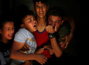 Relatives of a Palestinian, who was killed at the Israel-Gaza border, react at a hospital in Gaza City June 18, 2018. REUTERS/Mohammed Salem