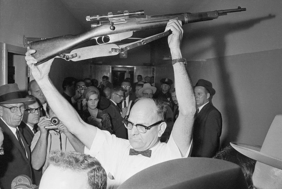 policeman holding rifle used in kennedy assassination