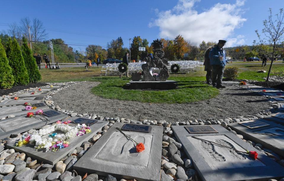 First responders look over the Reflections Memorial after a unveiling ceremony Oct. 5, 2019, on the one-year anniversary of the Schoharie limousine crash that killed 20 people next to the Apple Barrel Restaurant in Schoharie.