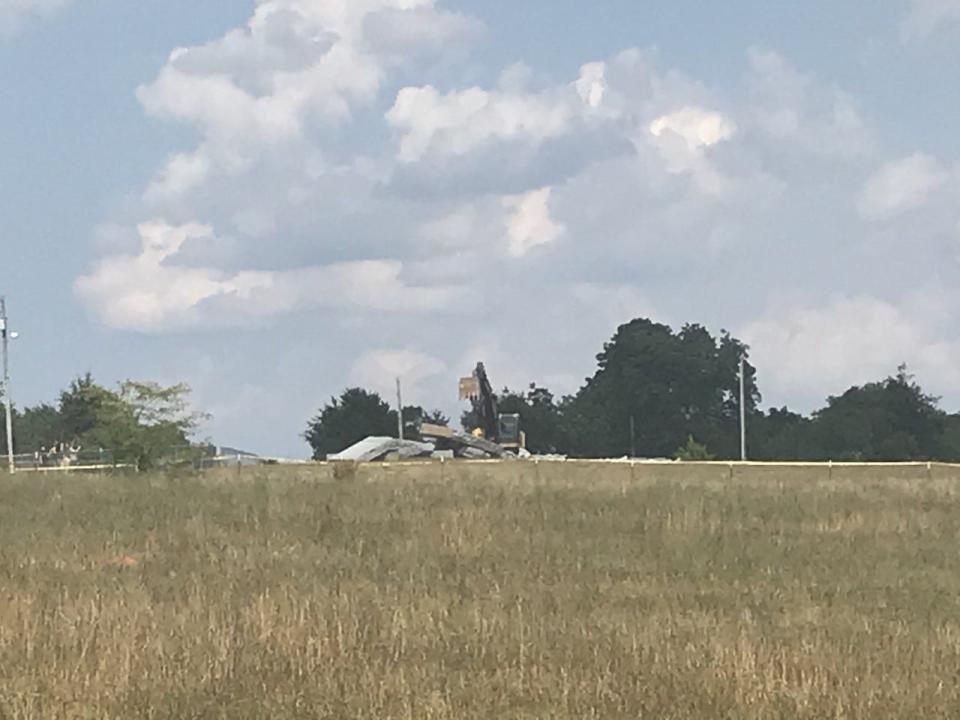 A backhoe on Wednesday, July 6, 2022, knocked over what remained of the Georgia Guidestones following an explosion earlier that day. GBI agents were on the scene it toppled.
