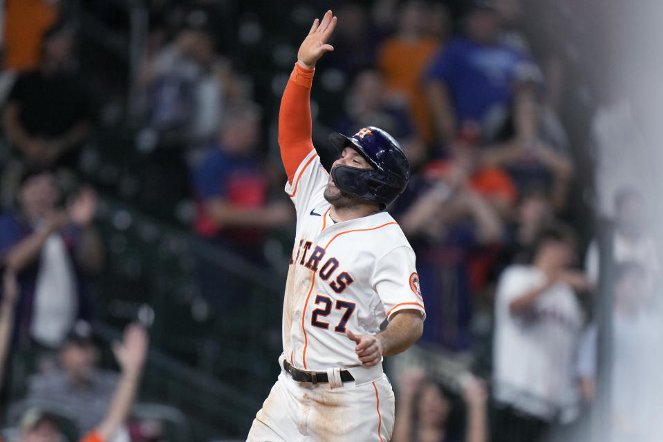 Houston Astros' Jose Altuve reacts after scoring the winning run on a wild pitch by Texas Rangers' Jonathan Hernandez during the 10th inning of a baseball game Wednesday, Sept. 7, 2022, in Houston. (AP Photo/Eric Christian Smith)