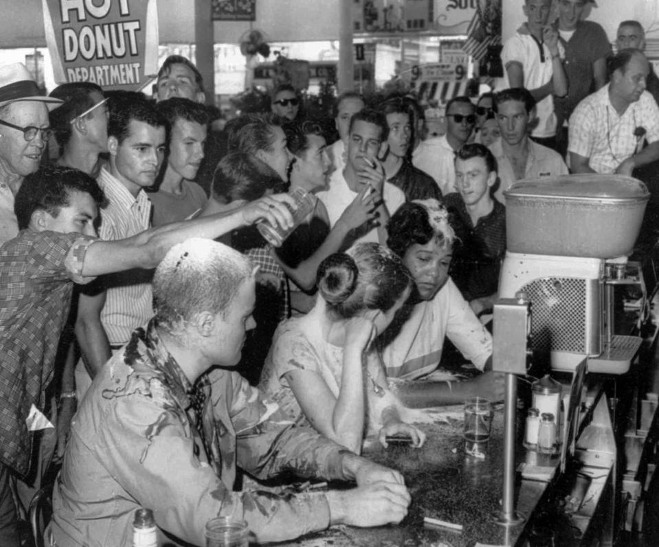This is a May 28, 1963 file photograph of a sit-in demonstration at a Woolworth's lunch counter in Jackson, Miss., where whites poured sugar, ketchup and mustard over heads of the demonstrators. Seated at the counter, from left, are John Salter, Joan Trumpauer and Anne Moody. 