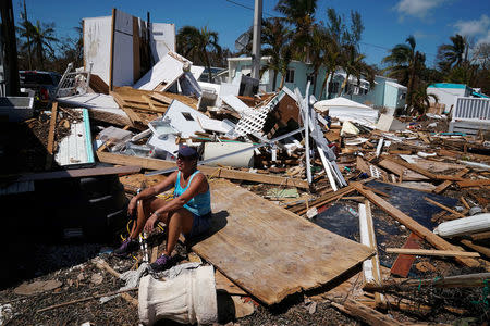 A resident sits in a debris field of former houses following Hurricane Irma in Islamorada, Florida, U.S., September 15, 2017. REUTERS/Carlo Allegri