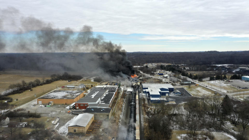 FILE - This photo taken with a drone shows portions of a Norfolk and Southern freight train that derailed Friday night in East Palestine, Ohio are still on fire at mid-day Saturday, Feb. 4, 2023. On Tuesday, April 9, 2024, Norfolk Southern has agreed to pay $600 million in a class-action lawsuit settlement related to a fiery train derailment in February 2023 in eastern Ohio. (AP Photo/Gene J. Puskar, File)