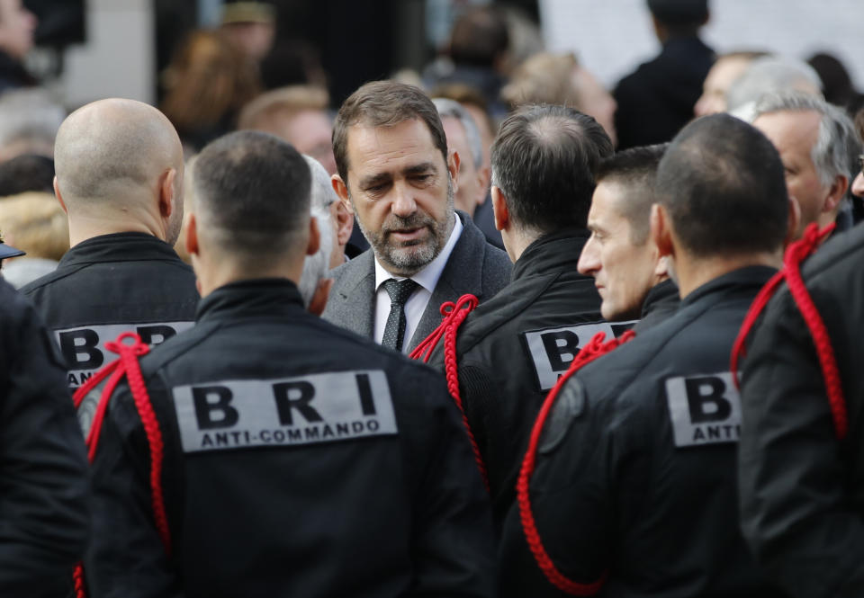 French Interior Minister Christophe Castaner, center, speaks with members of Research and Intervention Brigades (BRI) during a ceremony marking the third anniversary of the Paris attacks of November 2015 in which 130 people were killed, in Paris, Tuesday, Nov. 13, 2018. France's interior minister says French security services have foiled six terror attacks this year, as the country marks three years since gun and bomb attacks in Paris killed 130 people. (AP Photo/Christophe Ena)