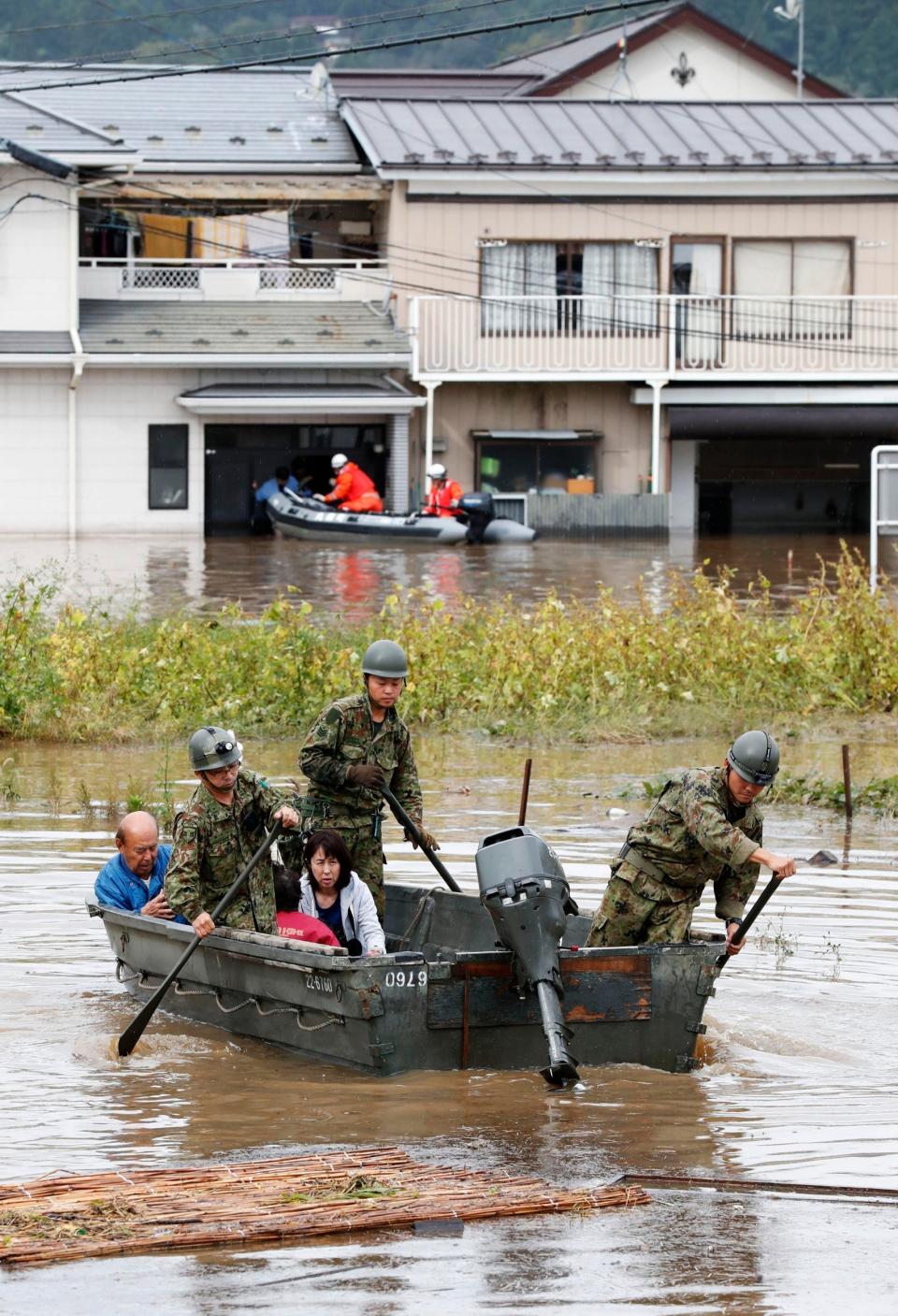 People are rescued in the Japanese town of Marumori on Monday (Kyodo News via AP)