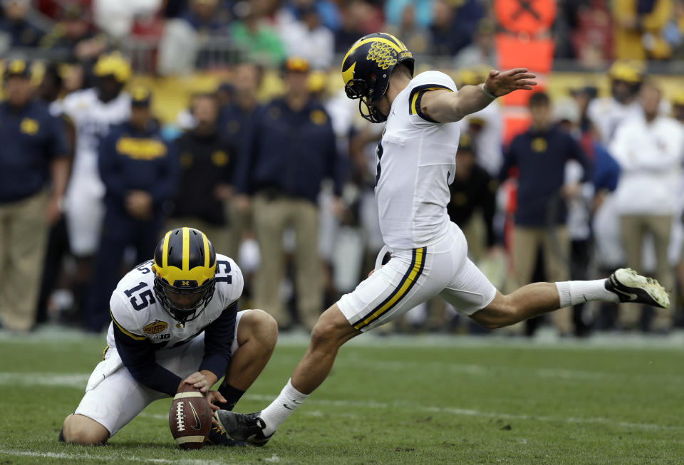 Michigan kicker Quinn Nordin (3) prepares to make a field goal against South Carolina during the first half of the Outback Bowl NCAA college football game Monday, Jan. 1, 2018, in Tampa, Fla. Holding is Garrett Moores. (AP Photo/Chris O’Meara)