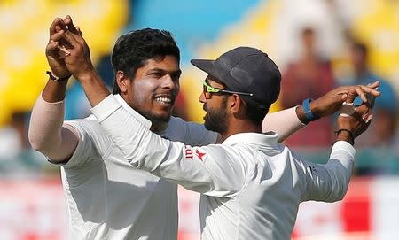 Cricket - India v Australia - Fourth Test cricket match - Himachal Pradesh Cricket Association Stadium, Dharamsala, India - 27/03/17 - India's Umesh Yadav (L) and Ajinkya Rahane celebrate the dismissal of Australia's Nathan Lyon. REUTERS/Adnan Abidi