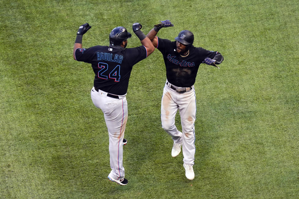 Jesus Aguilar celebrates with Starling Marte after hitting a home run in Game 1 of the wild-card series. The Marlins were victorious. (Photo by Nuccio DiNuzzo/MLB Photos via Getty Images)