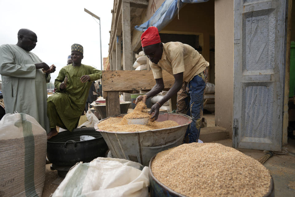 A man sells grain in Dawanau International Market in Kano Nigeria, Friday, July 14, 2023. Nigeria introduced programs before and during Russia's war in Ukraine to make Africa's largest economy self-reliant in wheat production. But climate fallout and insecurity in the northern part of the country where grains are largely grown has hindered the effort. (AP Photo/Sunday Alamba)