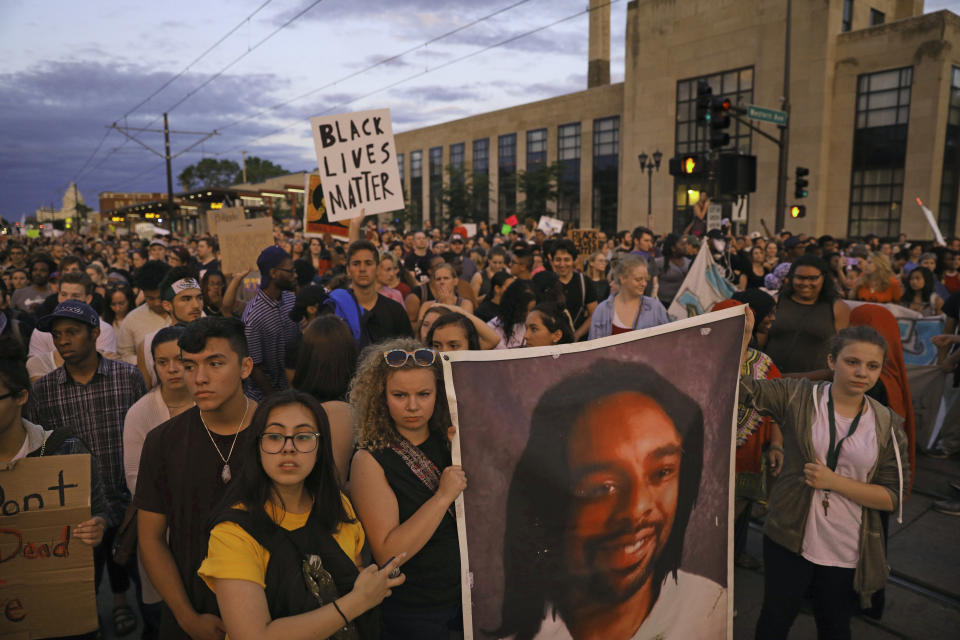 FILE - In this June 16, 2017 file photo, supporters of Philando Castile hold his portrait as they march along University Avenue in St. Paul, Minn., leaving a vigil at the state Capitol. The vigil was held after St. Anthony Police Officer Jeronimo Yanez was cleared of all charges in the fatal shooting of Castile. (Anthony Souffle/Star Tribune via AP)