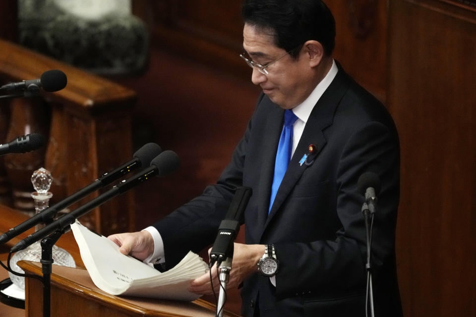 Japanese Prime Minister Fumio Kishida holds his speech paper after delivering speech during a Diet session at the lower house of parliament Monday, Jan. 23, 2023, in Tokyo. (AP Photo/Eugene Hoshiko)