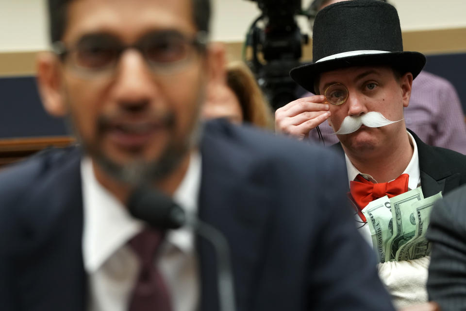 WASHINGTON, DC - DECEMBER 11: Ian Madrigal (R) dresses as Mr. Monopoly as Google CEO Sundar Pichai (L) testifies before the House Judiciary Committee at the Rayburn House Office Building on December 11, 2018 in Washington, DC. The committee held a hearing on 'Transparency & Accountability: Examining Google and its Data Collection, Use and Filtering Practices.”  (Photo by Alex Wong/Getty Images)