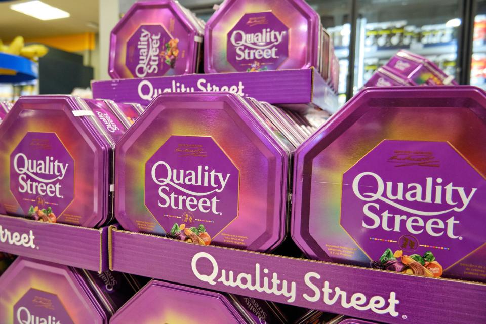 Supermarket stacked display of Quality Street chocolate boxes