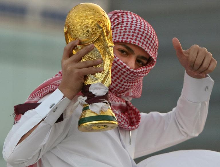 A Qatari youth holds a mock World Cup trophy during celebrations in Doha after the world football's governing body FIFA announced that the tiny Gulf state will host the 2022 World Cup on December 3, 2010