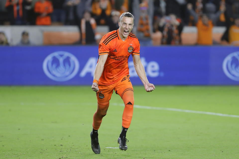 Houston Dynamo midfielder Griffin Dorsey reacts after scoring the winning goal in the penalty shootout against Real Salt Lake in overtime of the second half of an MLS playoff soccer match Saturday, Nov. 11, 2023, in Houston. (AP Photo/Michael Wyke)