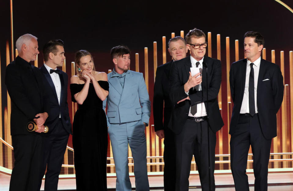 Martin McDonagh, Colin Farrell, Kerry Condon, Barry Keoghan, Brendan Gleeson, Graham Broadbent, and Peter O'Brien accept the Best Motion Picture — Musical or Comedy award.