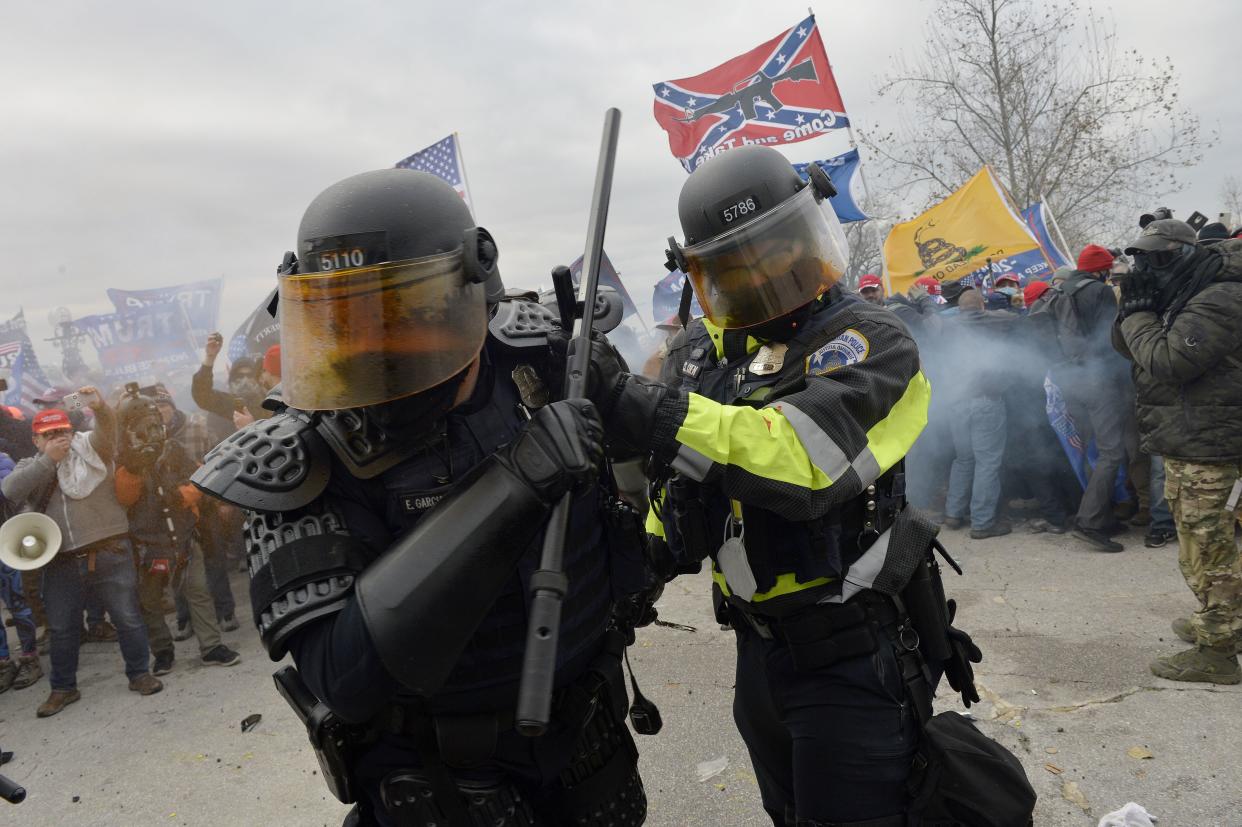 Trump supporters clash with police and security forces as they try to storm the US Capitol in Washington, DC on January 6, 2021.