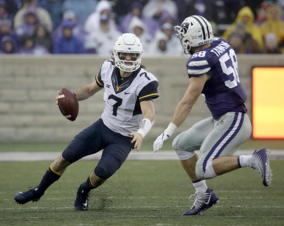 West Virginia quarterback Will Grier (7) runs under pressure from Kansas State linebacker Trent Tanking (58) during the first half of an NCAA college football game, Saturday, Nov. 11, 2017, in Manhattan, Kan. (AP Photo/Charlie Riedel)