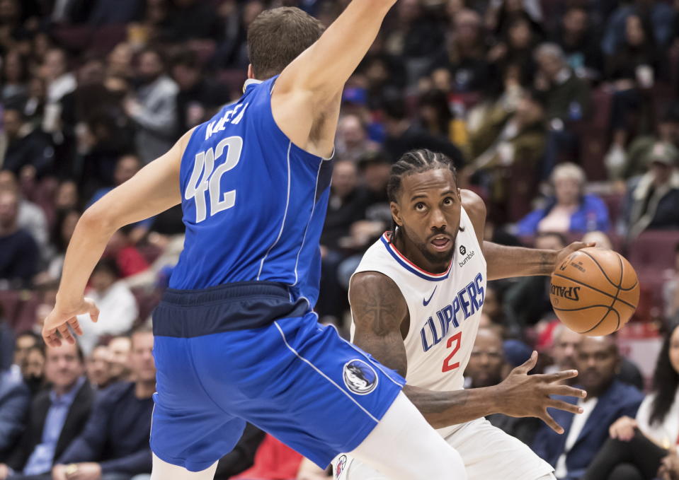 Los Angeles Clippers' Kawhi Leonard (2) drives against Dallas Mavericks' Maxi Kleber (42) during the first half of an NBA preseason basketball game Thursday, Oct. 17, 2019, in Vancouver, British Columbia. (Darryl Dyck/The Canadian Press via AP)