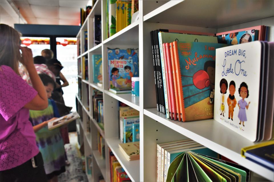 Patrons search for the latest children's books at The Nolensville Book Nook at the store's grand opening on Sunday, July 31, 2022 in downtown Nolensville, Tenn. The women-owned business offers a variety of books for families to purchase and enjoy together.