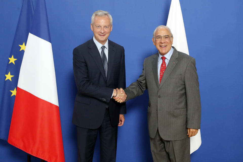 French Finance Minister Bruno Le Maire, left, meets with OECD chief Angel Gurria to plan for international taxes on digital giants like Amazon and Google at Bercy Economy ministry in Paris, Thursday, Aug. 29, 2019. France recently introduced a 3% tax on the companies' French revenues, prompting U.S. President Donald Trump to threaten tariffs on French wine in response.(AP Photo/Francois Mori)