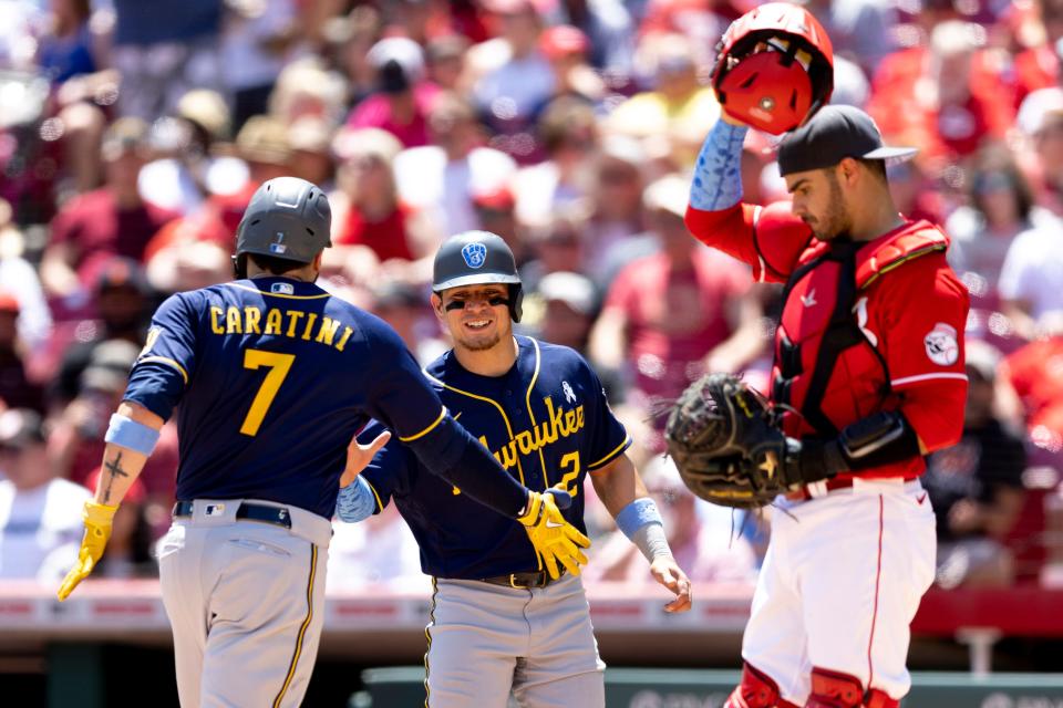 Milwaukee Brewers catcher Victor Caratini (7) celebrates with Milwaukee Brewers shortstop Luis Urias (2) after hitting a 2-run home run in the fourth inning of the MLB game between the Cincinnati Reds and the Milwaukee Brewers in Cincinnati at Great American Ball Park on Sunday, June 19, 2022. 