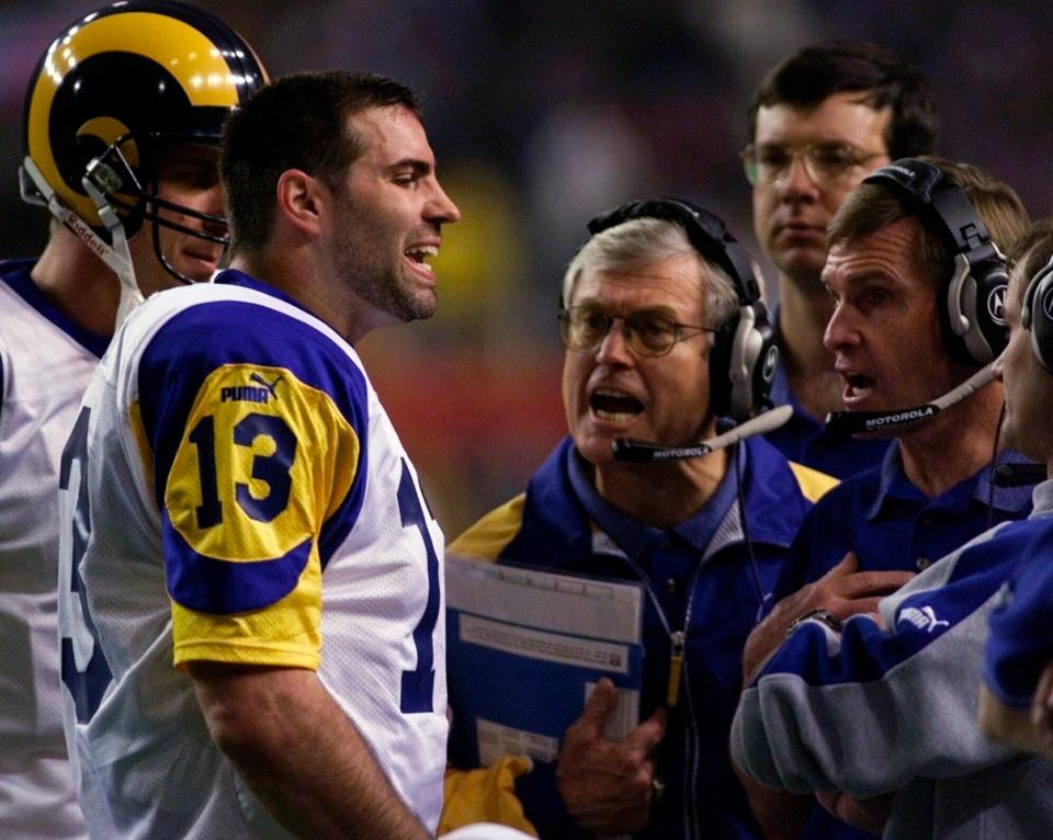 St. Louis Rams quarterback Kurt Warner talks to Rams head coach Dick Vermeil, at center, and other coaches during a timeout in the second quarter in Super Bowl XXXIV in Atlanta, Jan. 30, 2000.