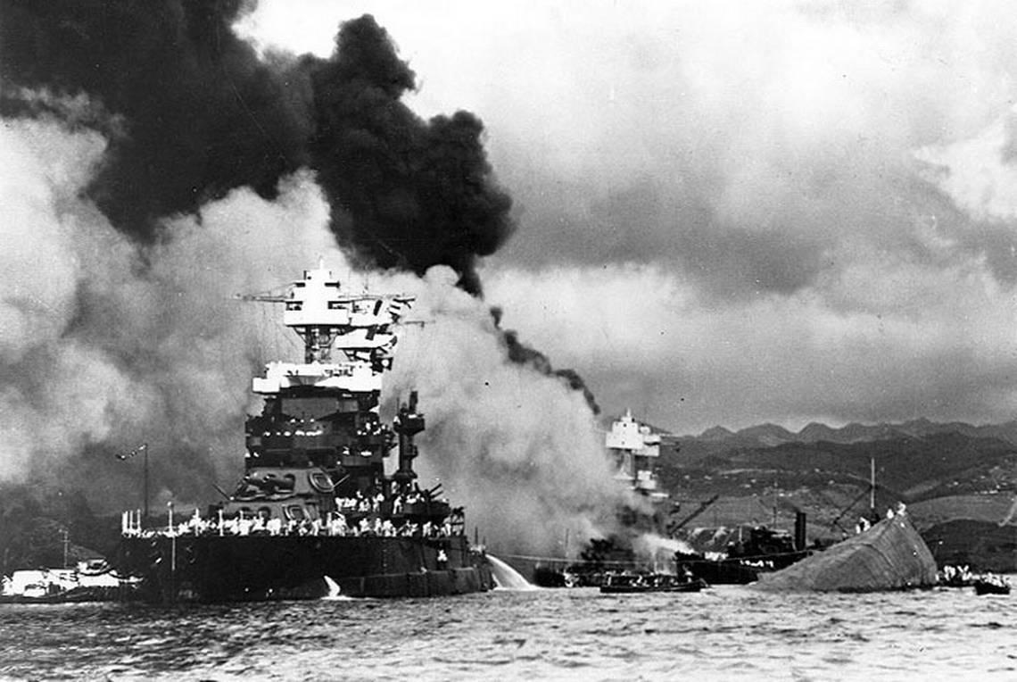 The battleship USS Oklahoma, right, lays capsized alongside the USS Maryland following Japan’s surprise attack on Pearl Harbor on Dec. 7, 1941. The Oklahoma’s position in the harbor made it an easy target for the first Japanese torpedo planes to arrive.