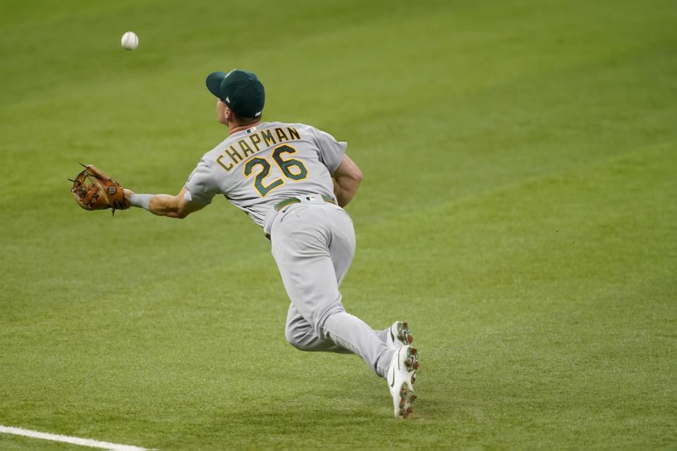 Oakland Athletics third baseman Matt Chapman makes a diving catch on a flyout by Texas Rangers' Brock Holt in the fifth inning of a baseball game in Arlington, Texas, Saturday, Aug. 14, 2021. (AP Photo/Tony Gutierrez)