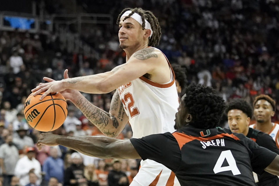 Miami guard Bensley Joseph blocks a shot by Texas forward Christian Bishop in the first half of an Elite 8 college basketball game in the Midwest Regional of the NCAA Tournament Sunday, March 26, 2023, in Kansas City, Mo. (AP Photo/Charlie Riedel)