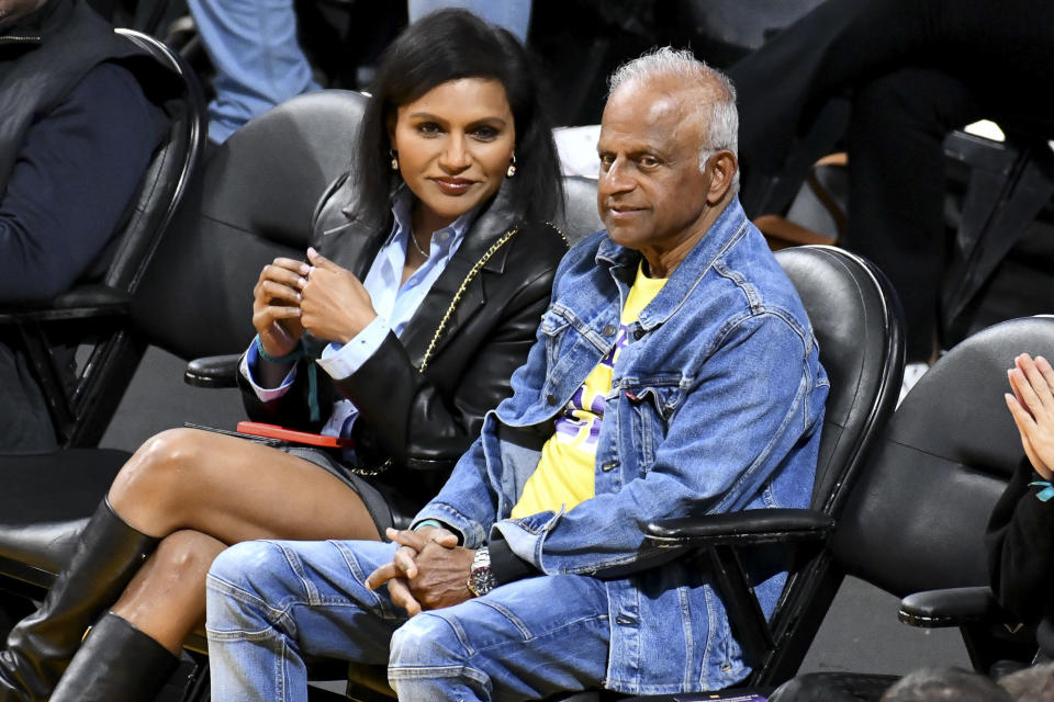 <p>Los Angeles Lakers fans <a href="https://people.com/tag/mindy-kaling/" rel="nofollow noopener" target="_blank" data-ylk="slk:Mindy Kaling;elm:context_link;itc:0;sec:content-canvas" class="link ">Mindy Kaling</a> and her father, Avu Chokalingam, sit courtside at the team's game against the Golden State Warriors at Crypto.com Arena on Feb. 23. </p>