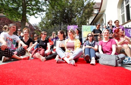 Teachers and mothers of pupils take part in a strike in front of the Aemtler school in Zurich