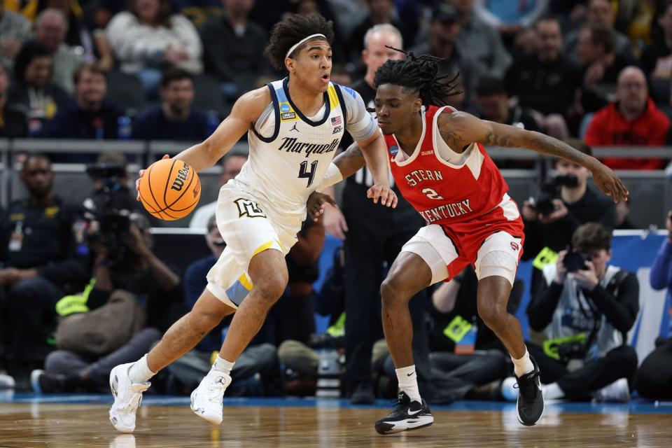 Mar 22, 2024; Indianapolis, IN, USA; Marquette Golden Eagles guard Stevie Mitchell (4) controls the ball against Western Kentucky Hilltoppers guard Don McHenry (2) in the first half in the first round of the 2024 NCAA Tournament at Gainbridge FieldHouse. Mandatory Credit: Trevor Ruszkowski-USA TODAY Sports