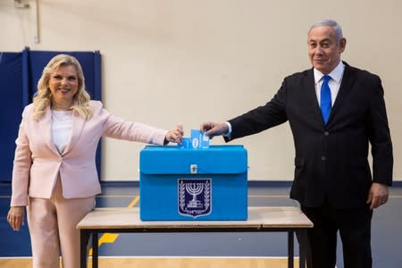 Israeli Prime Minister Benjamin and his wife Sara casts their votes during Israel's parliamentary election at a polling station in Jerusalem