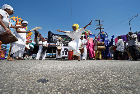 A dancer performs at the intersection of Florence and Normandie Avenue, the flashpoint where the riots started 25 years ago, during a march and rally to remember and honor the victims of the 1992 Los Angeles riots in Los Angeles, California, U.S., April 29, 2017. REUTERS/Kevork Djansezian