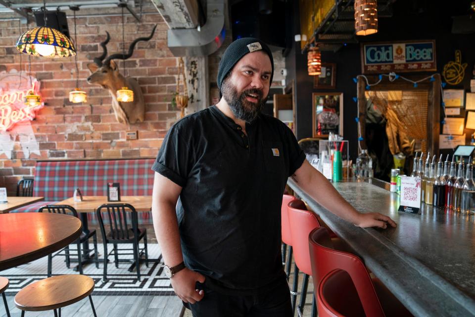 Nick Silas, 32, of Dearborn, at Second Best bar in Detroit on Tuesday, March 22, 2022. Silas is reinventing himself away from the food industry, squeezing in computer programming lessons around his restaurant work.