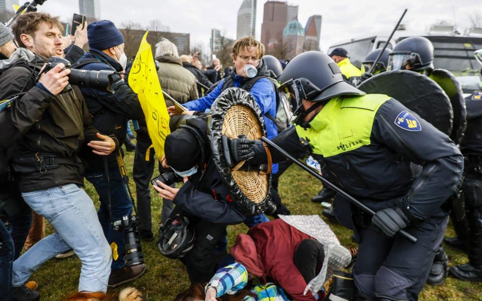 Dutch riot police break up a crowd of lockdown protesters - AFP