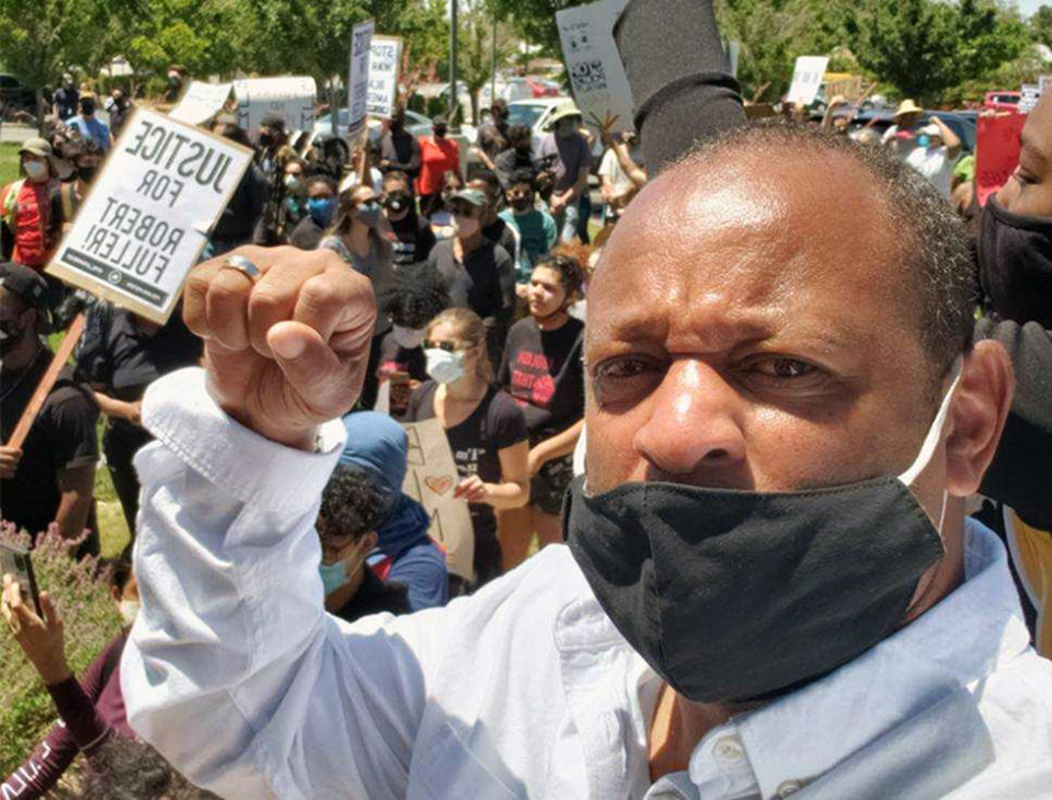 This Saturday, June 13, 2020, photo provided by Najee Ali, shows activist Najee Ali at a rally in the park where the body of Robert Fuller was found dead Wednesday, June 10 in Poncitlan Square in Palmdale, Calif. People marched to demand an investigation into the death of 24-year-old Robert Fuller, who was found hanging from a tree early Wednesday near City Hall. The protesters marched from where the body was found to a sheriff's station, with many carrying signs that said "Justice for Robert Fuller." (Najee Ali via AP)