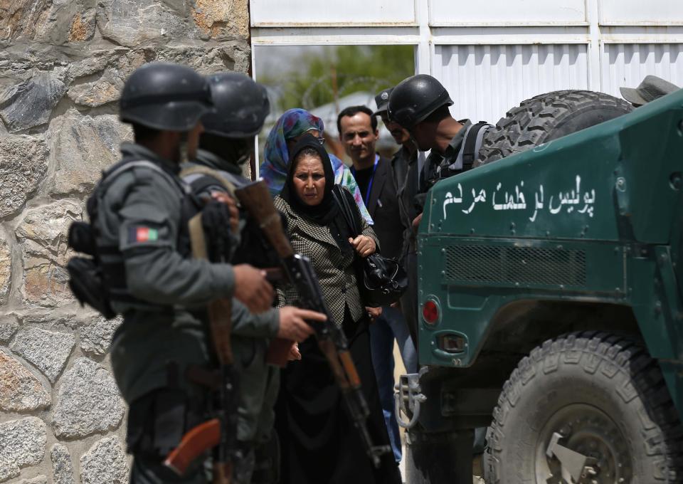 Women leave the Cure Hospital after three foreigners were killed in Kabul April 24, 2014. (REUTERS/Mohammad Ismail)