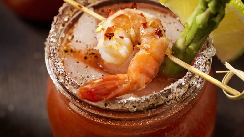 Close-up of a Bloody Mary garnished with shrimp and asparagus