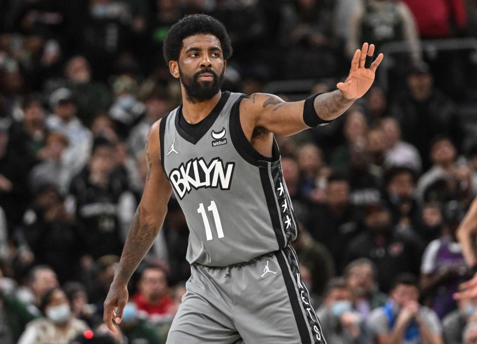 Brooklyn Nets guard Kyrie Irving reacts during a timeout in the fourth quarter against the Milwaukee Bucks at Fiserv Forum.